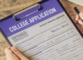 College admissions officer using AI detection tools to review a student’s application essay on a computer