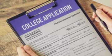 College admissions officer using AI detection tools to review a student’s application essay on a computer