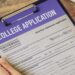 College admissions officer using AI detection tools to review a student’s application essay on a computer