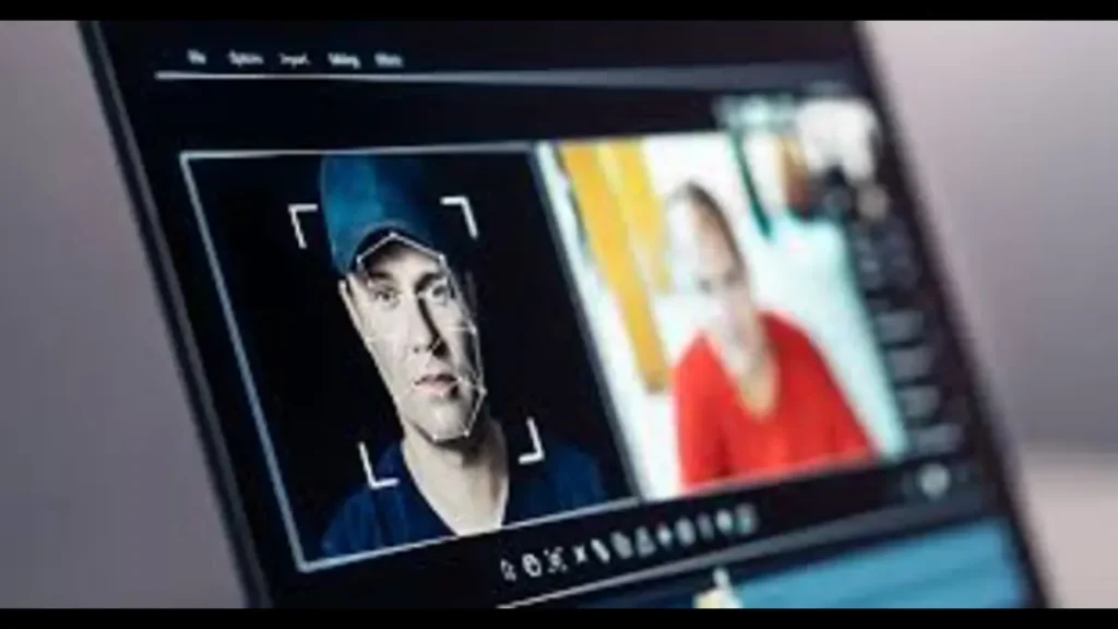 Deepfake video conference showing face recognition interface on a laptop screen.