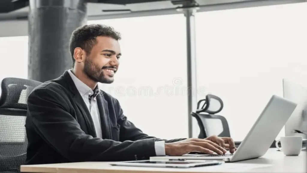 Office worker using Microsoft Copilot on a desktop computer in a modern workspace.