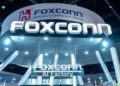 Foxconn AI server production line with workers assembling high-performance computing equipment for global distribution.