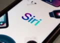 iPhone using the new Siri powered by Apple Intelligence for hands-free control.